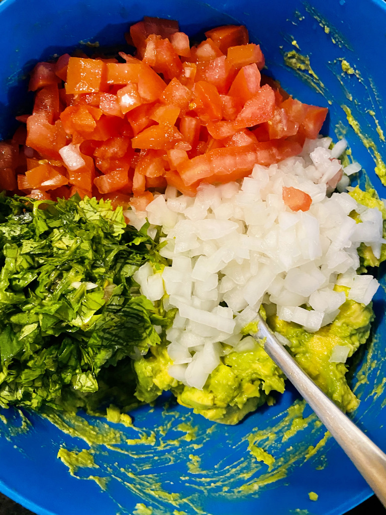 Chopped guacamole ingredients, ready for mixing with the avocado