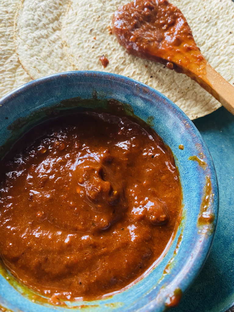 Chile morita salsa with tostadas in a blue pottery bowl