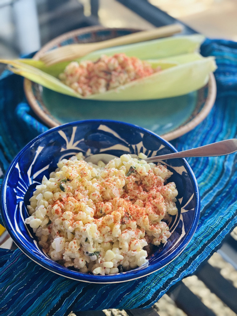 Mexican street corn, in a bowl and in corn husks