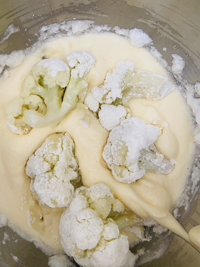 Cauliflower pieces in the egg batter