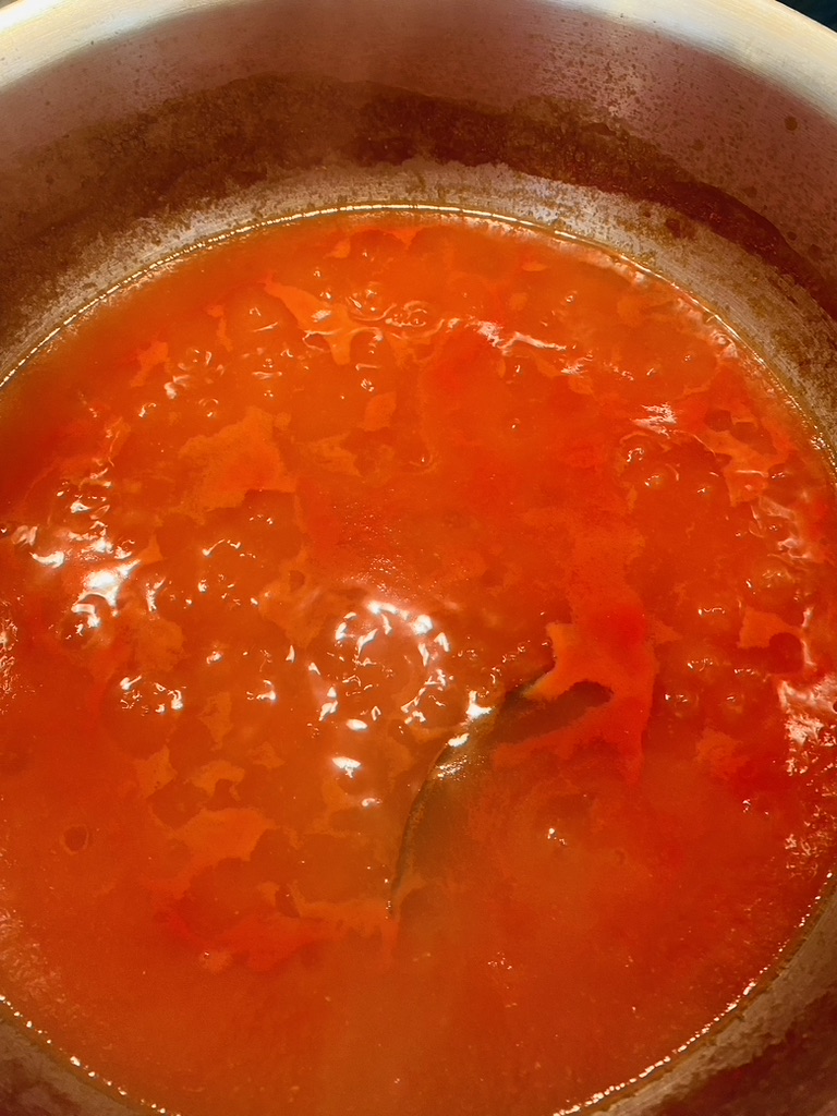 Tomato-based sauce in a pan that has darkened and cooked