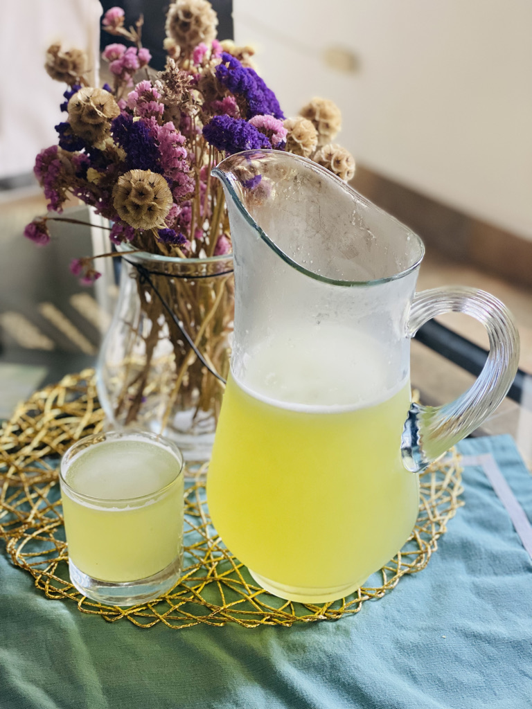 Prickly pear water in a glass and pitcher