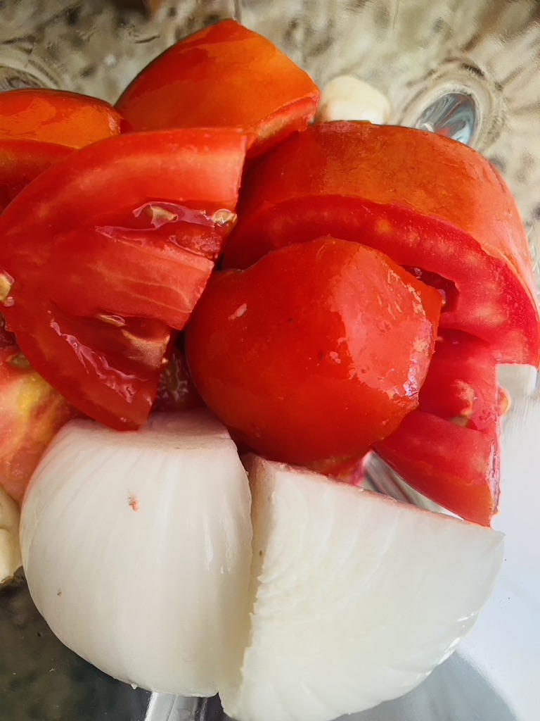 Cut up tomatoes, onions, and garlic in a blender to make sauce