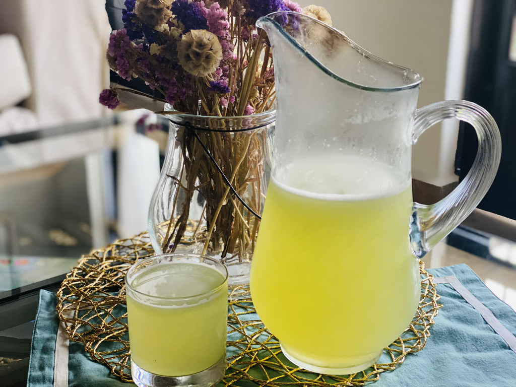 Refreshing prickly pear water in a glass and pitcher