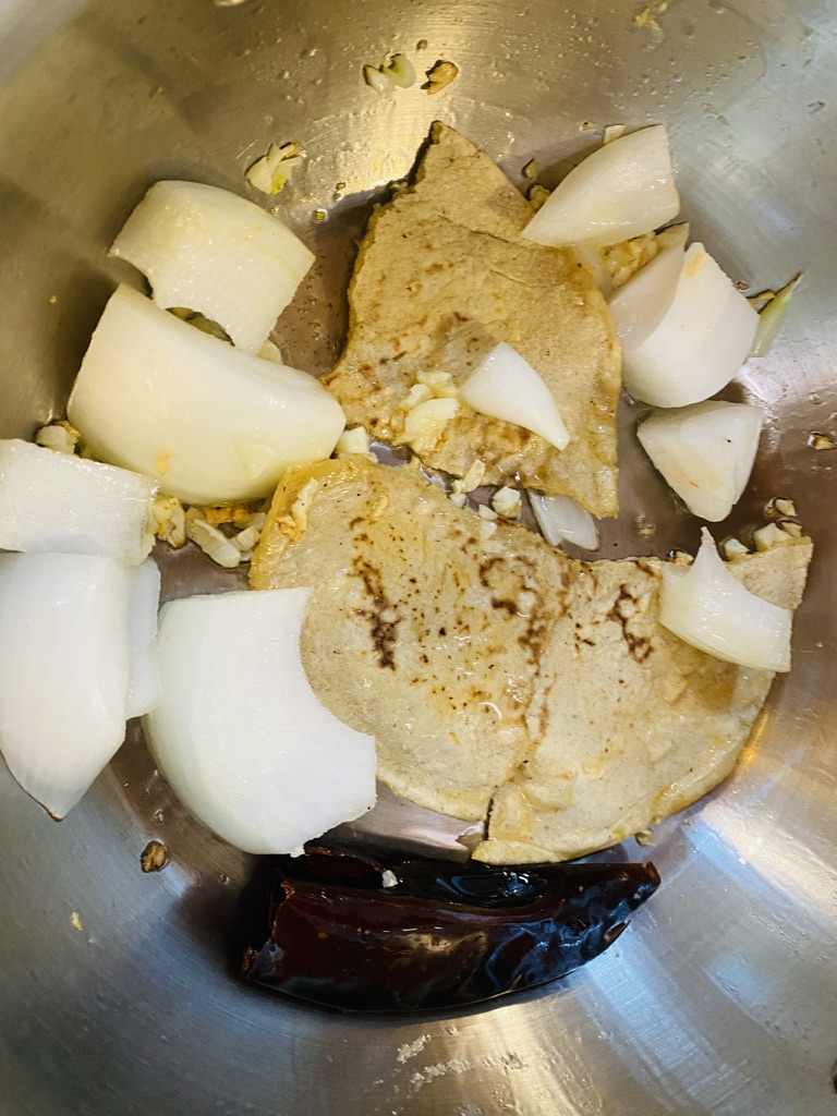 Tortilla, onion, garlic and chile frying for tortilla soup