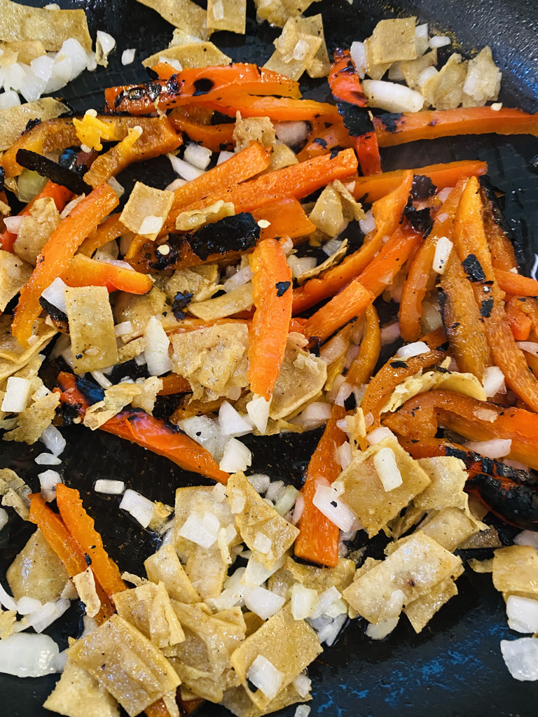 Tortilla, onion and red peppers frying