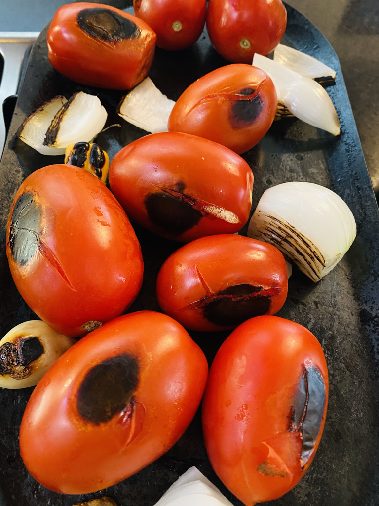 Salsa roja ingredients roasting on comal