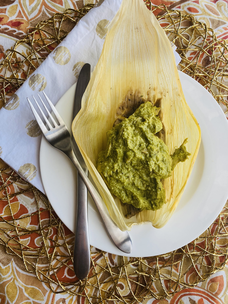 Mole verde over a black bean tamal
