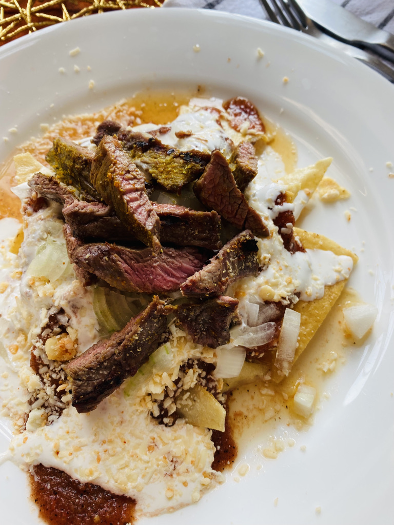 Chilaquiles with charred salsa roja and grilled steak