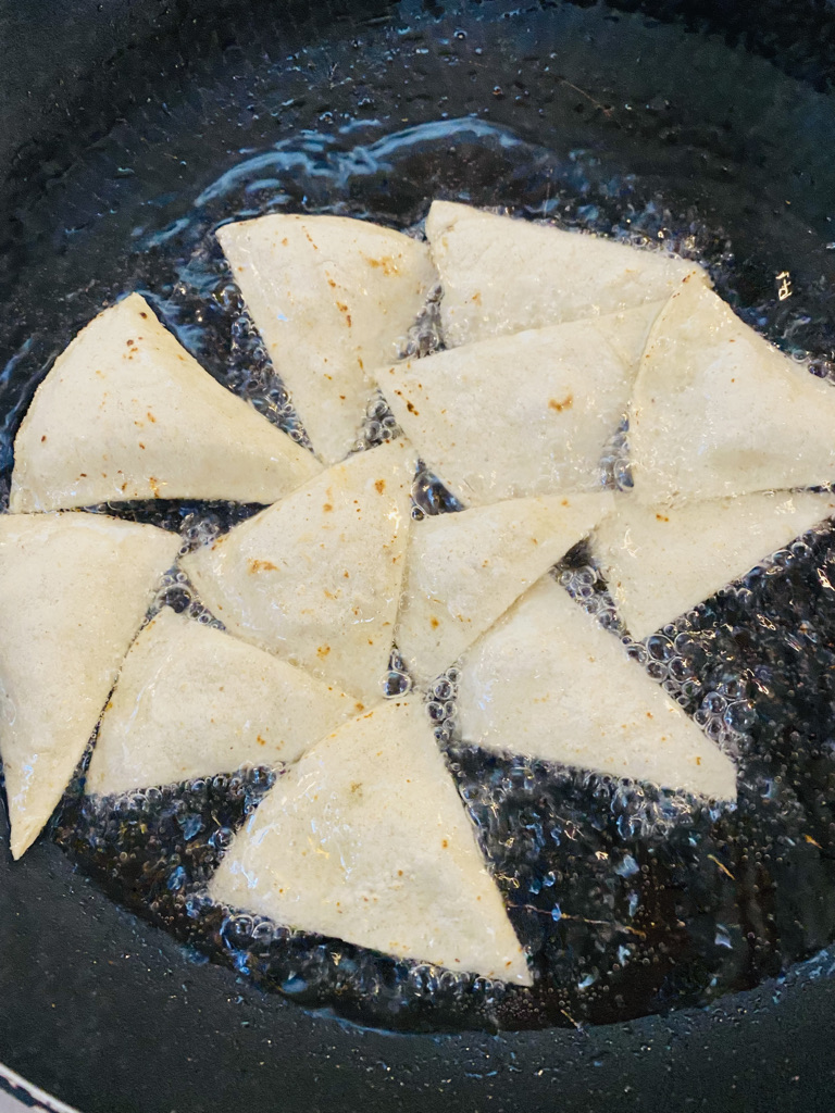 Corn tortilla wedges frying