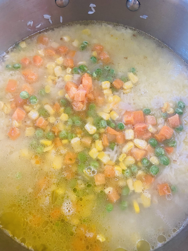 White rice cooking with vegetables