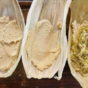 Tamal assembly, 3 corn husks with masa spread inside, one husk with salsa verde and chicken filling