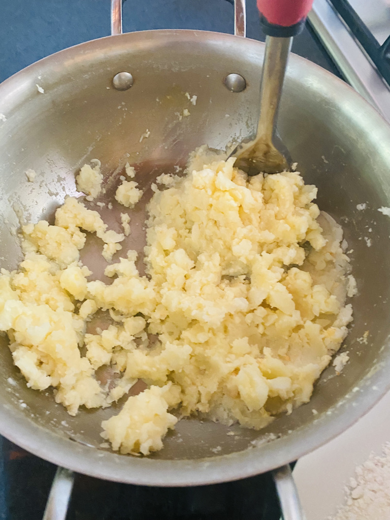 White potatoes being mashed