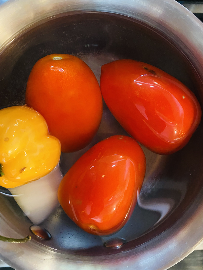 Tomato and habanero salsa ingredients in pot