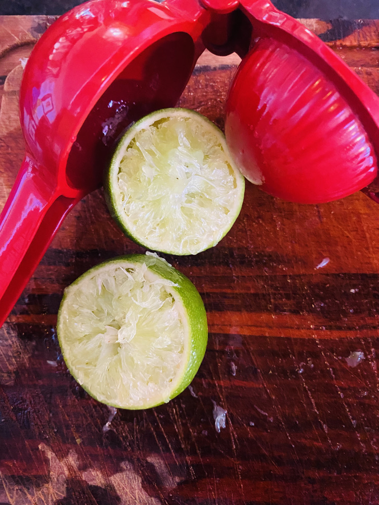 Squeezed limes with handheld juicer