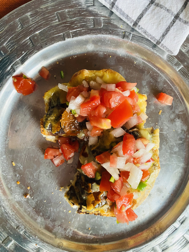 Close up Mexican mollete with pico de gallo on a silver plate