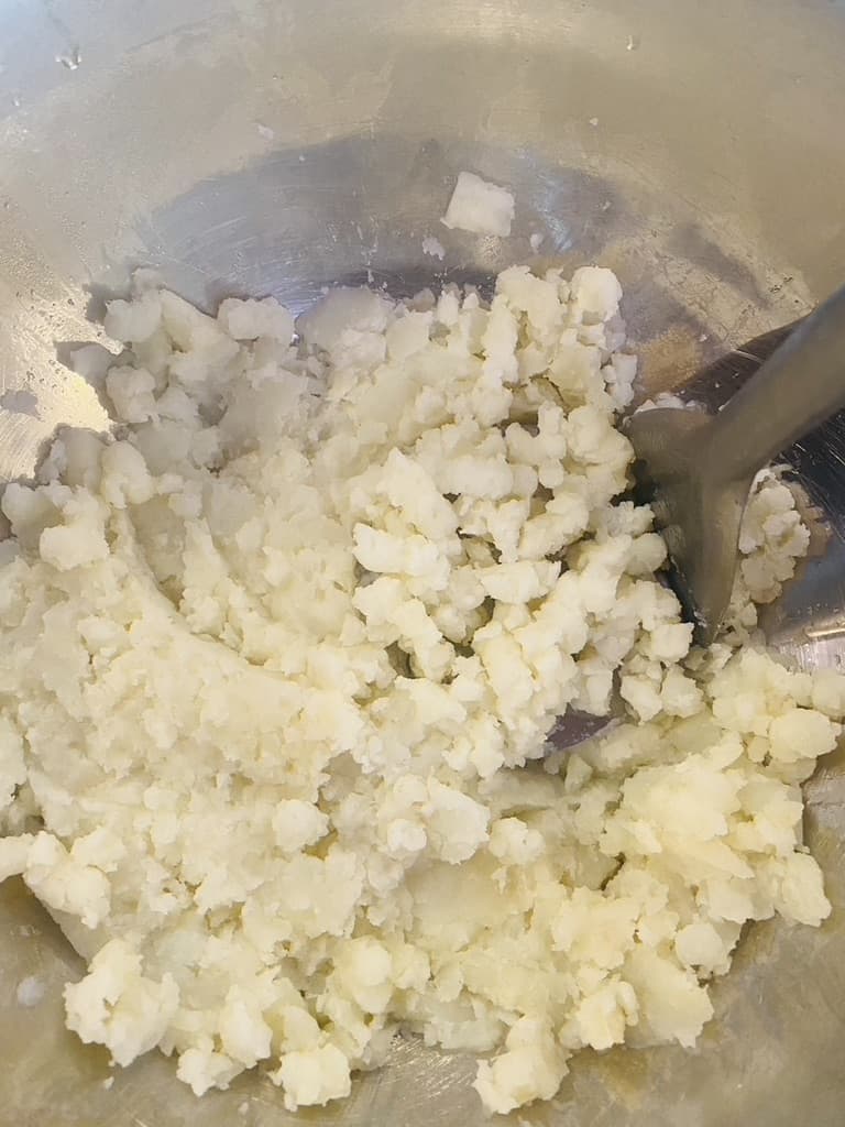 Mashing potatoes by hand