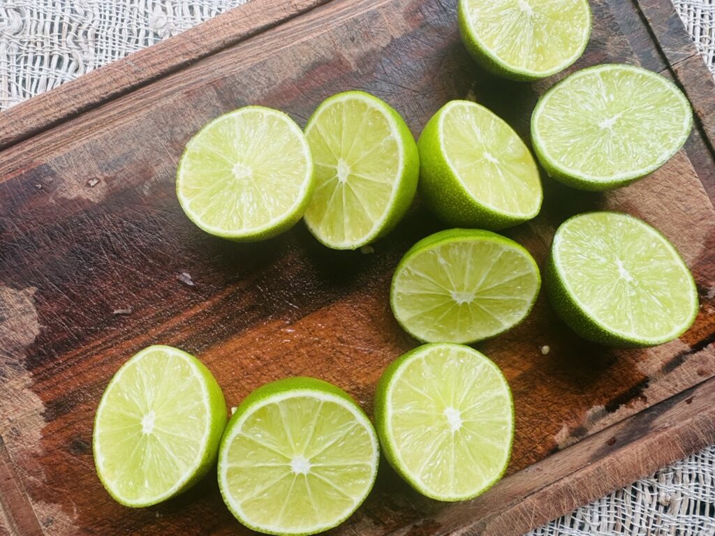 Sliced limes on a wooden cutting board