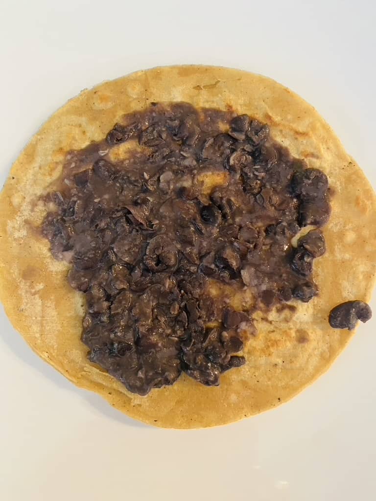 Corn tortilla topped with black beans