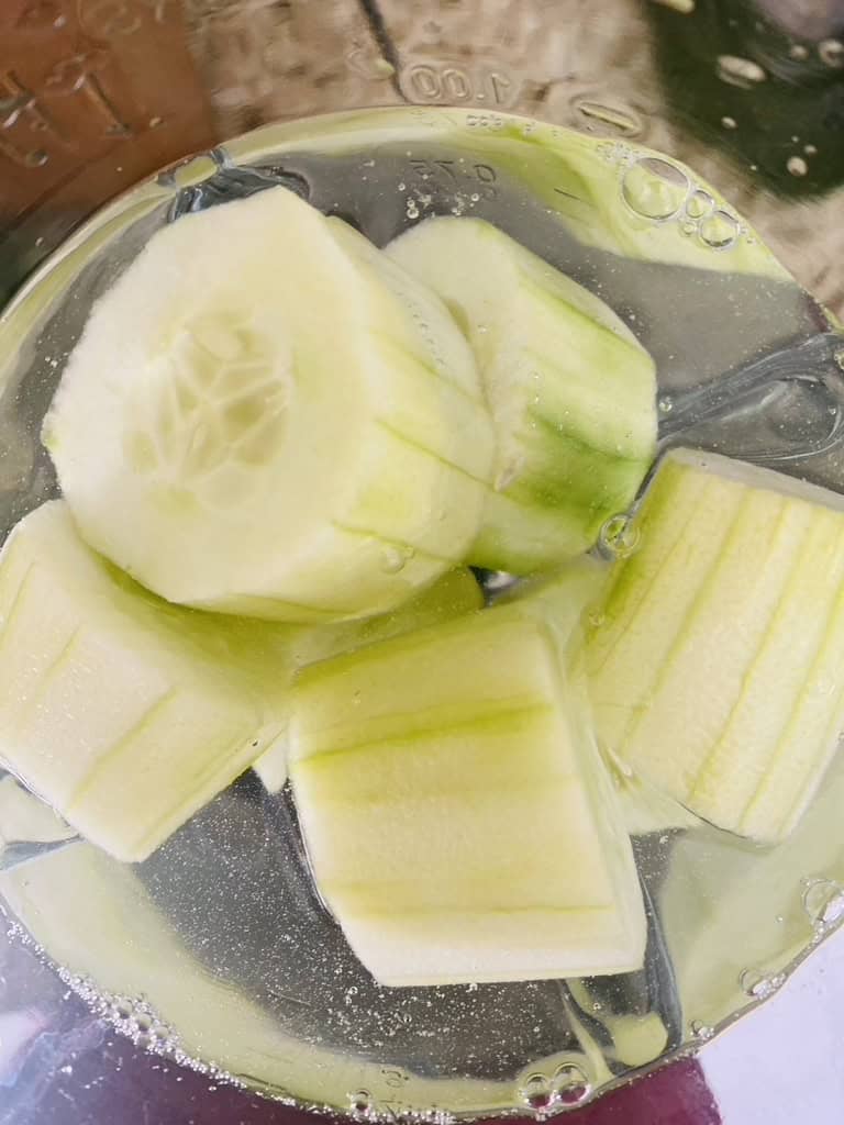 Cucumber chunks with water in a blender