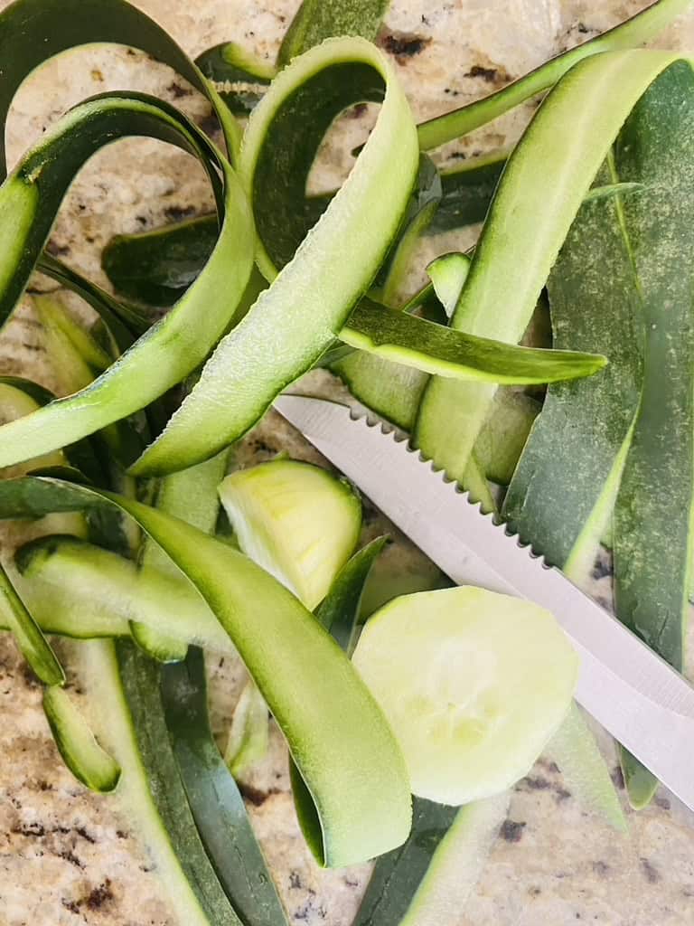 Cucumber peels and knife