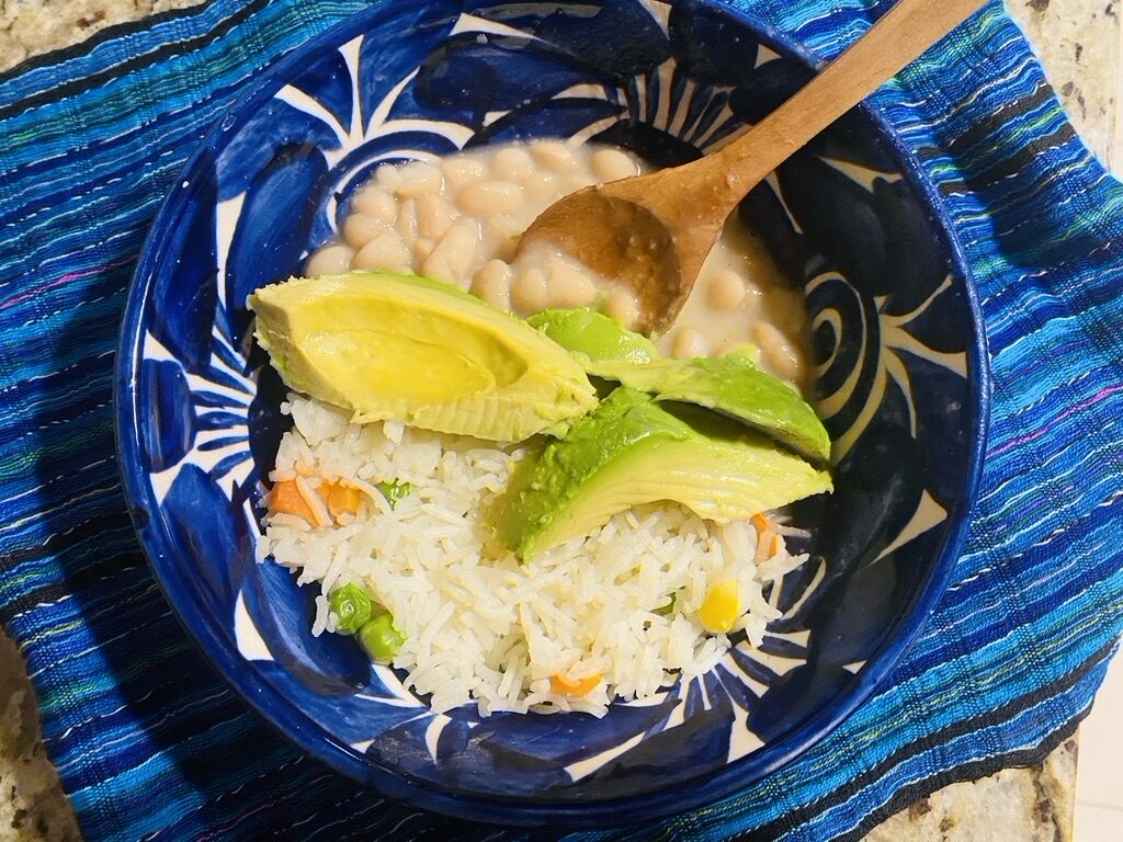 Peruvian beans with Mexican rice and avocado in a bowl