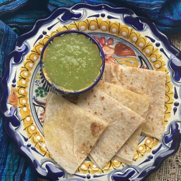 Sincronizadas on a Mexican talavera plate with green salsa