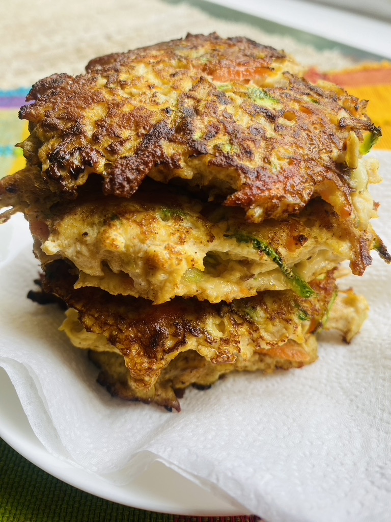 Mexican chicken and vegetable fritters stacked on a plate