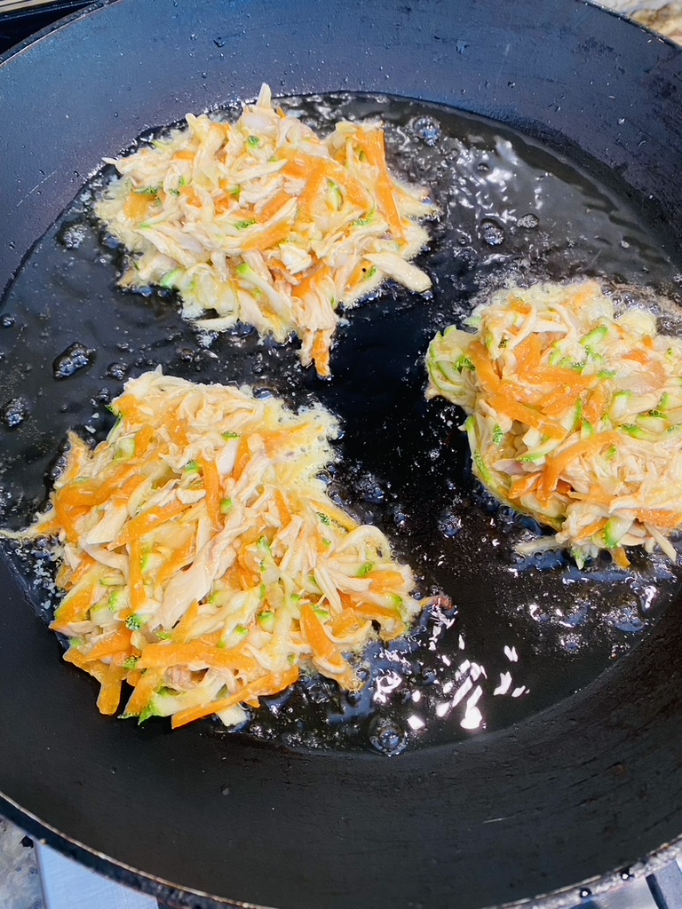 Mexican chicken and vegetable fritters frying in hot oil