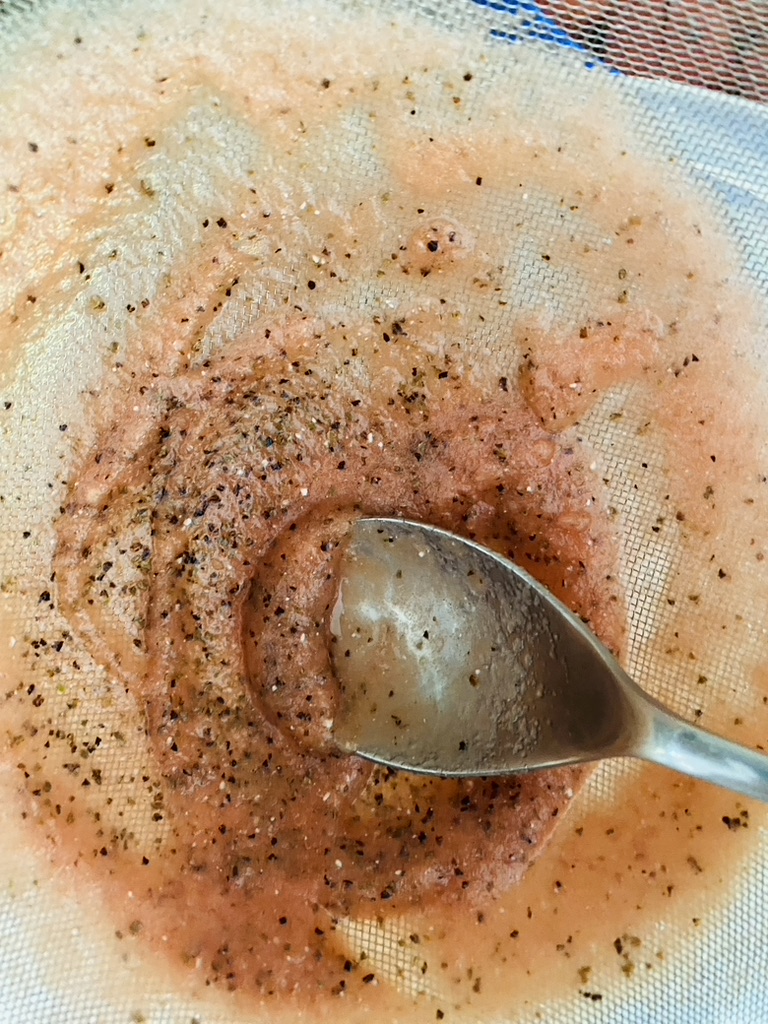Leftover watermelon pulp and seeds after being strained through a fine meshed sieve.