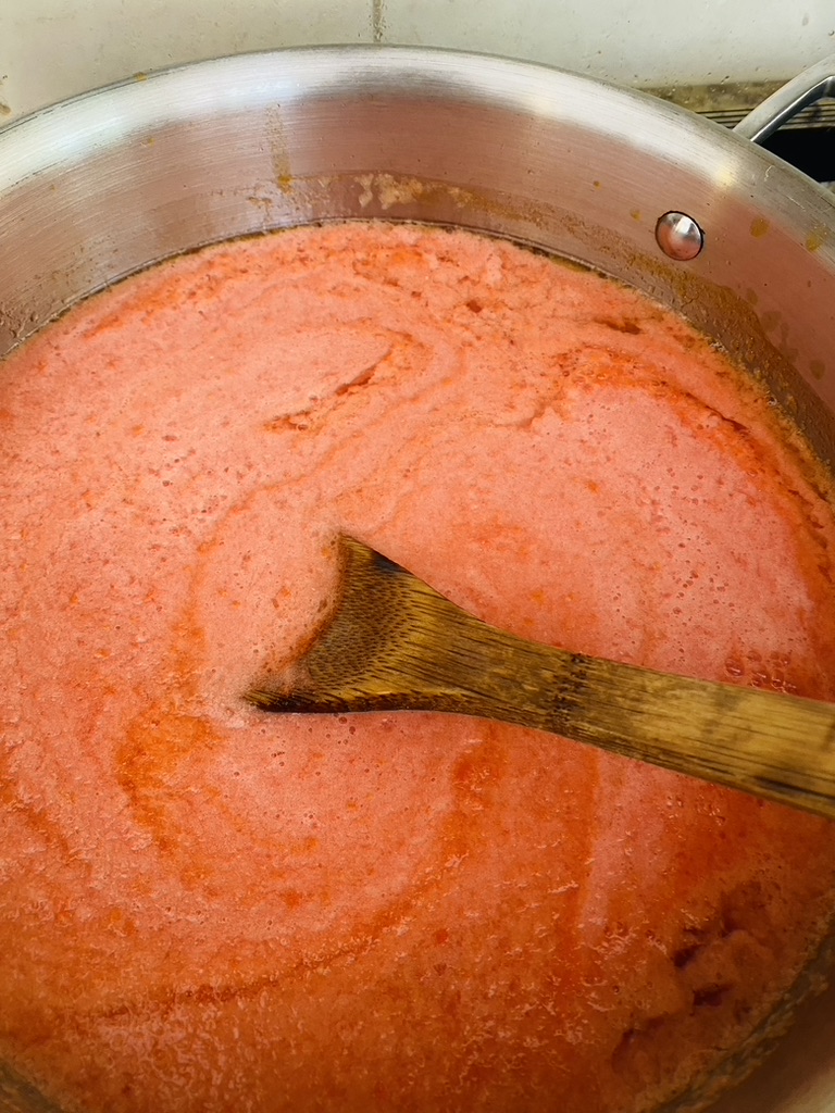 Tomato based broth that has just started cooking 