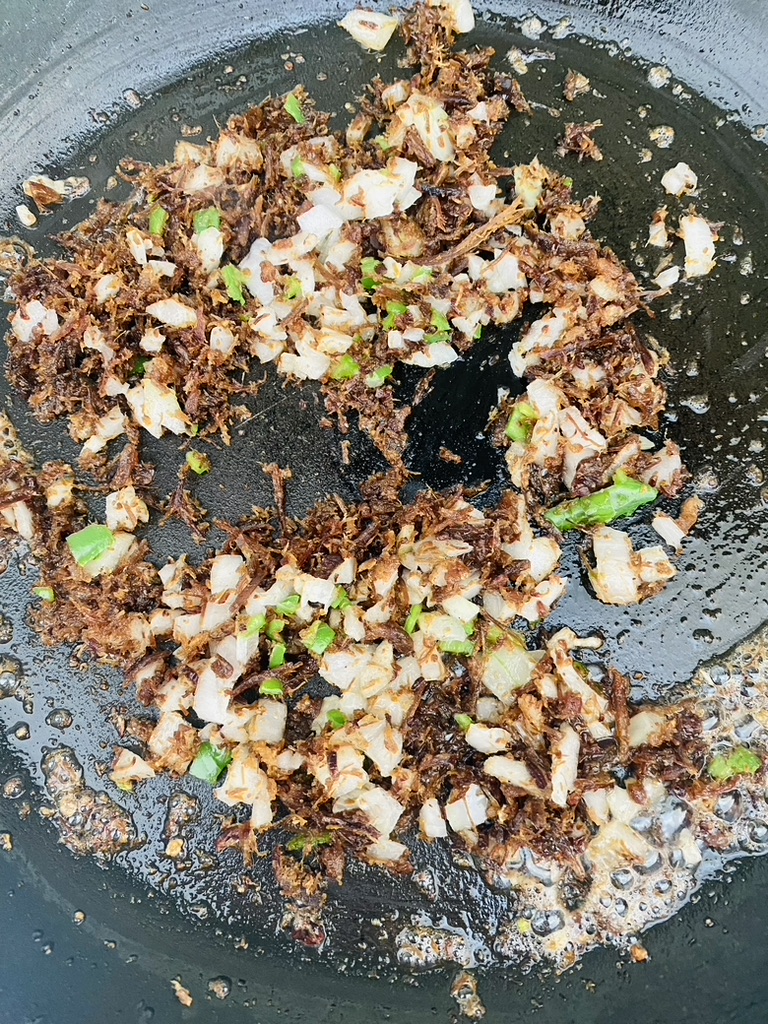 Machaca, onions, and chile pepper sauteeing in oil