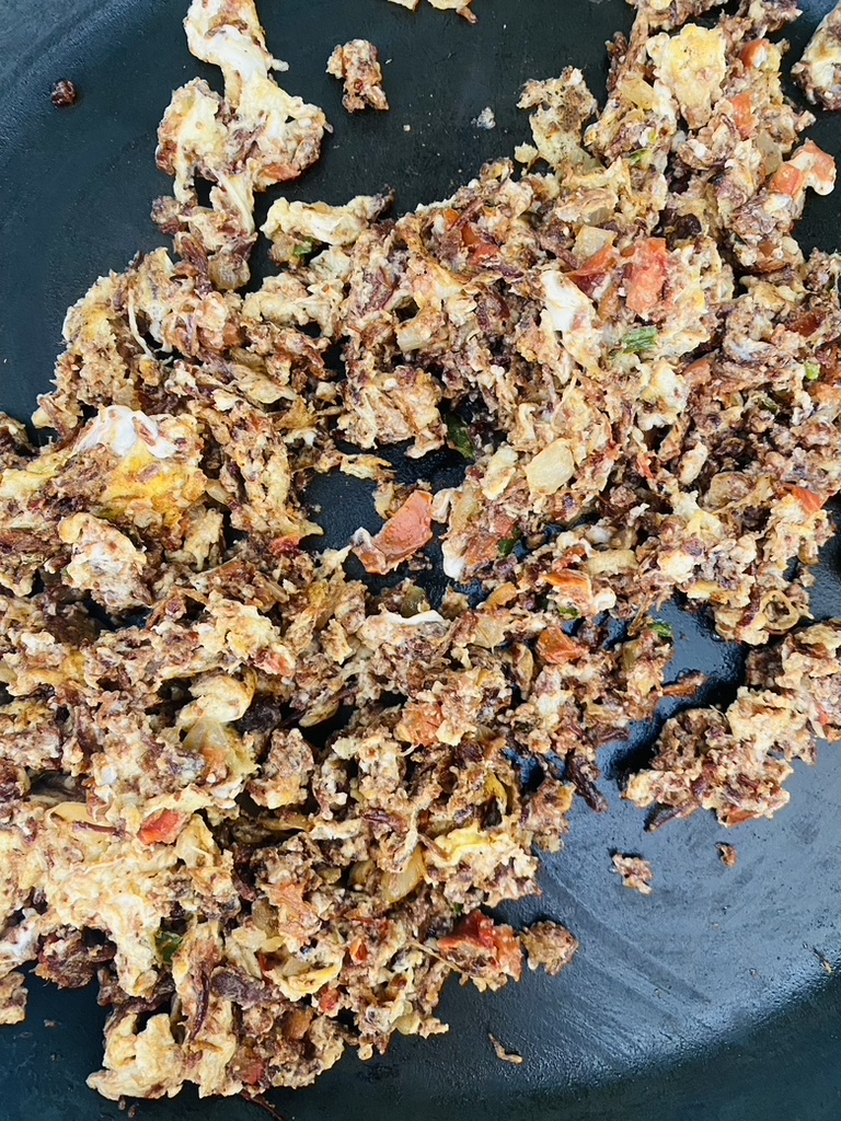 Finished machaca and egg scramble in frying pan with veggies