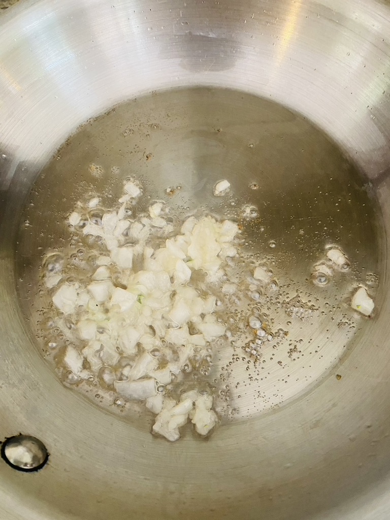 Onion frying in a lard in a skillet