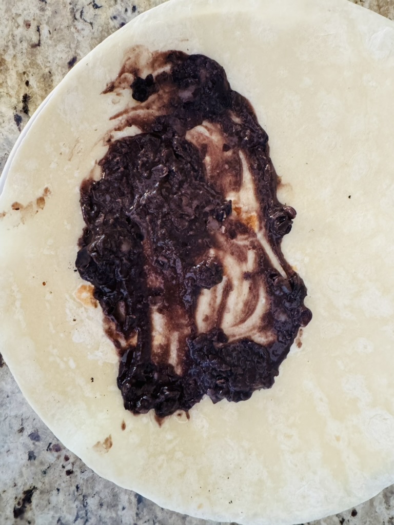 Flour tortilla with black refried beans