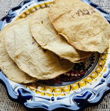 4 baked homemade tostadas on a talavera plate