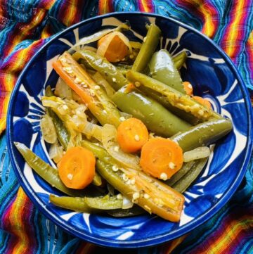Blue talavera bowl with pickled jalapeños, carrots, and onions.