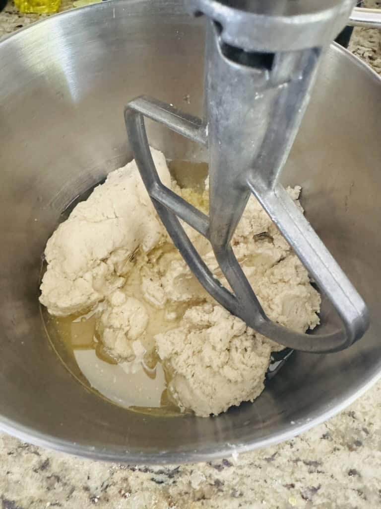 Vegan tamal masa ingredients in the bowl of a stand mixer